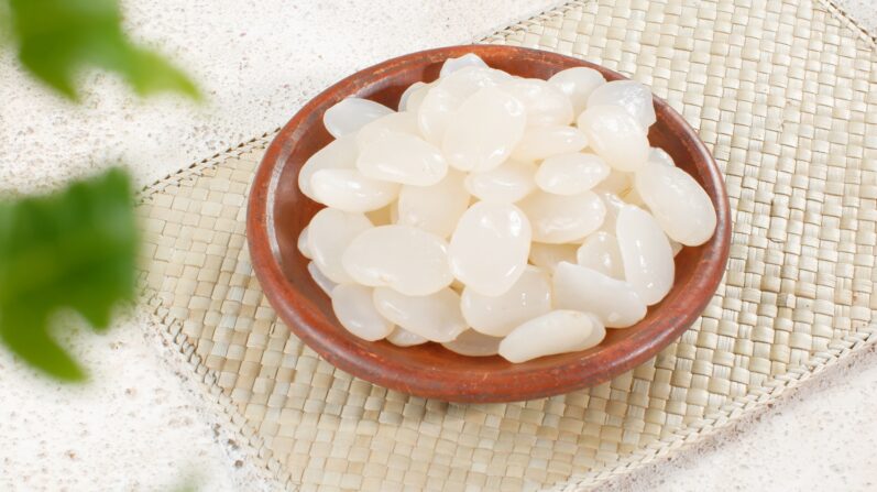 Gardening: For Green-Fingered People 5 sugar palm fruit in traditional pottery plate on white background