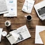Technology: Apps, Websites, SEO, Security and Digital Tools 5 A laptop on a coffee table with a coffee mug and a notebook, side hustle vibe