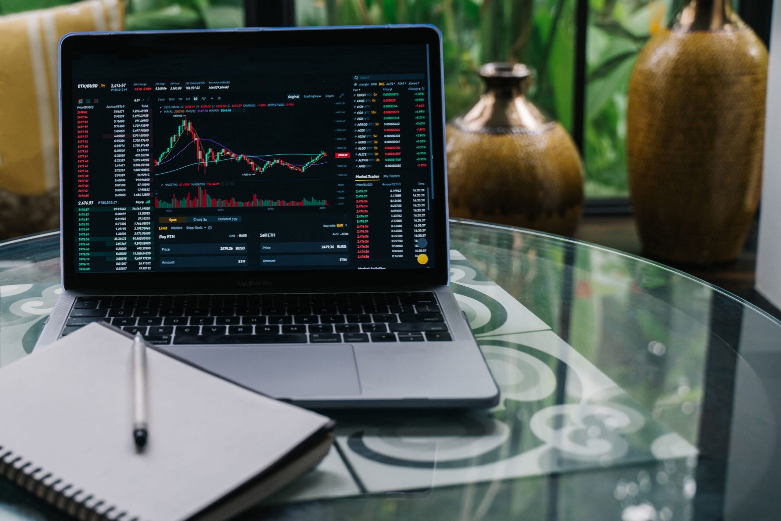 A laptop screen displaying Ethereum price chart with a coffee mug beside it