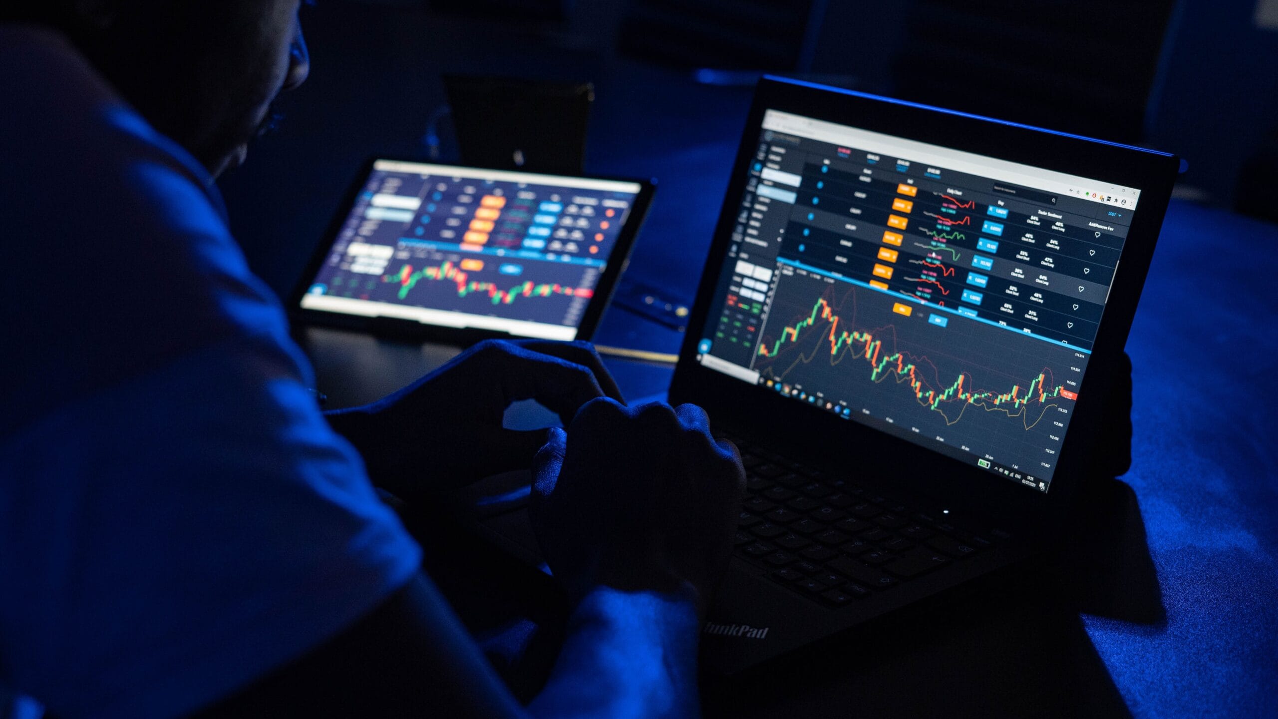 Forex Factory Calendar: Timing Trades for Extra Cash 4 Trader watching live forex news on a dual monitor setup