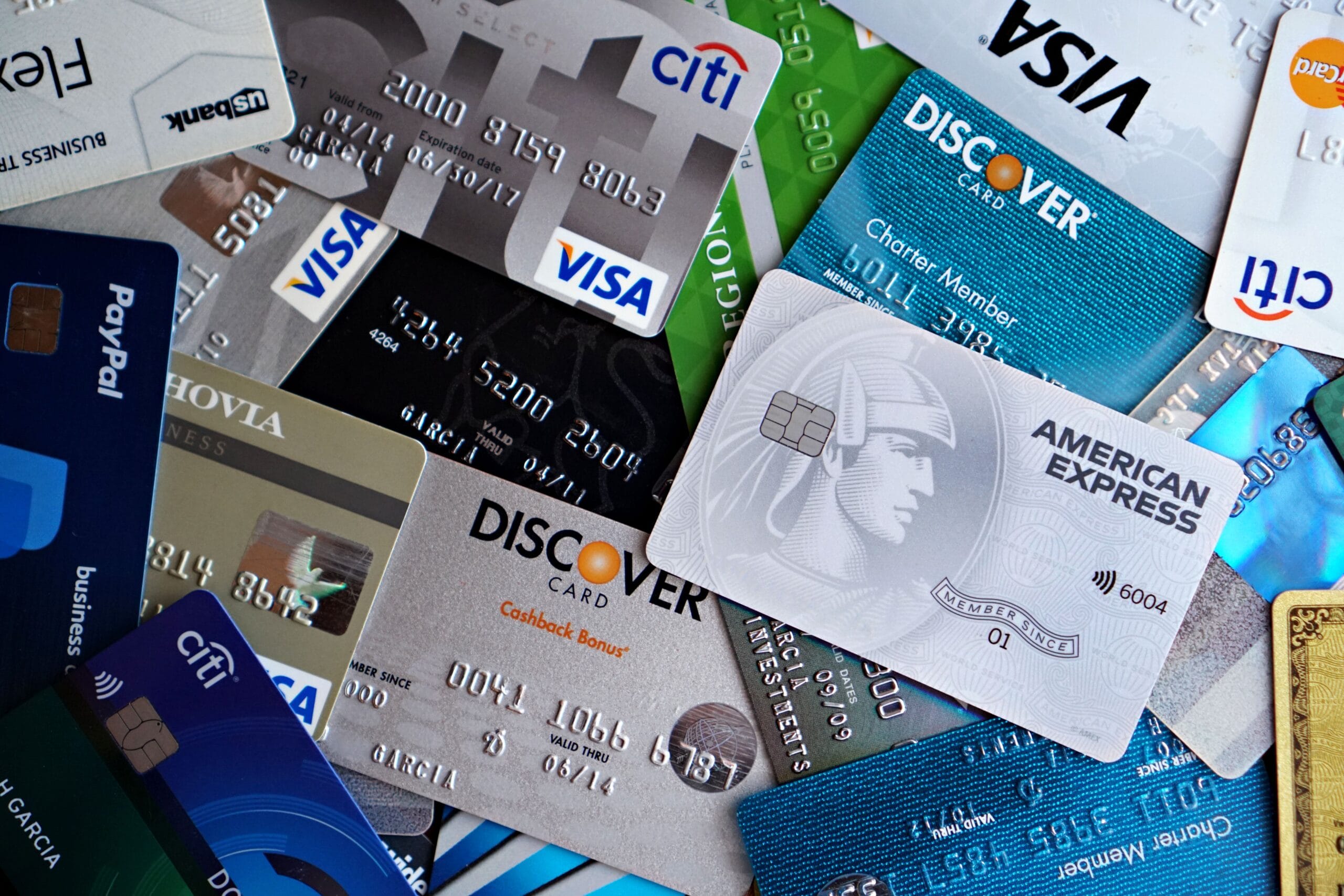 Online surveys that pay: A Practical Guide 5 Hand holding a PayPal card next to a gift card bundle
