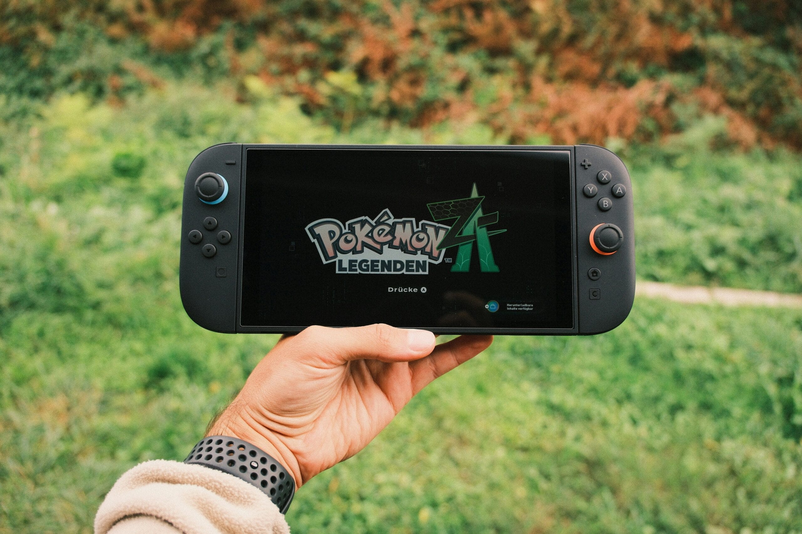 Is Nintendo Stock a Safe Bet for Side Hustlers? 3 Nintendo Switch console with game cartridges scattered on a table