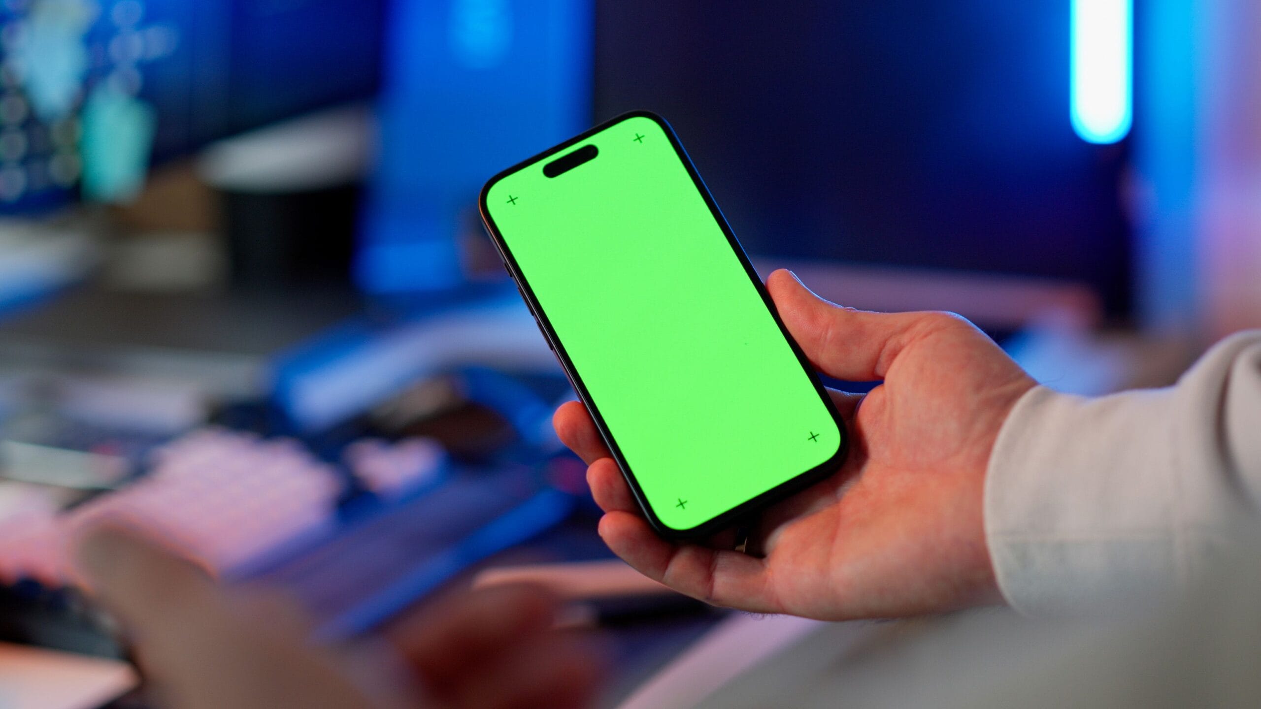 Person using a smartphone to test a new mobile app while taking notes