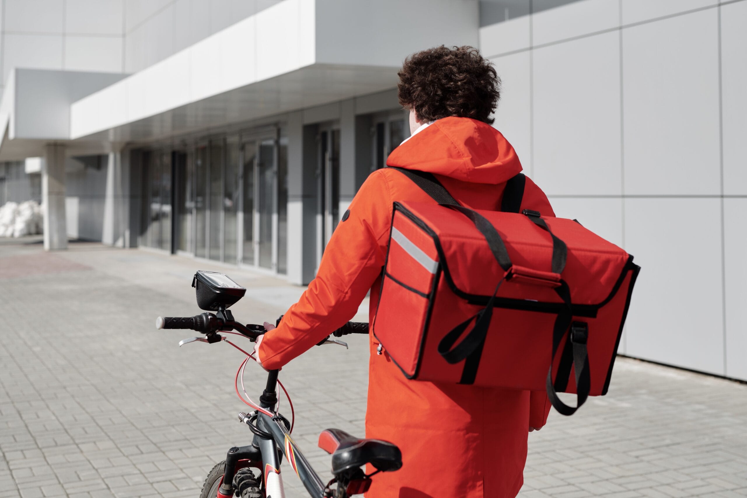 Best Instant Payout Micro Jobs & Apps for Gig Workers 5 A gig worker delivering groceries on a bike in an urban neighborhood