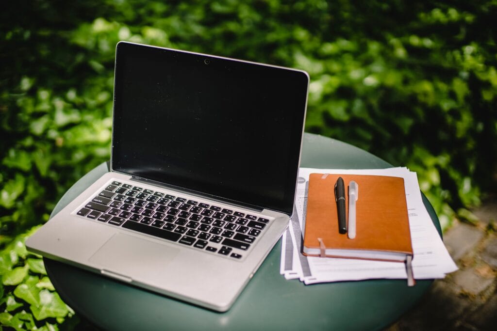 Highest Paying Online Focus Groups in 2026 4 Person working on a laptop in a home office with a garden visible through the window