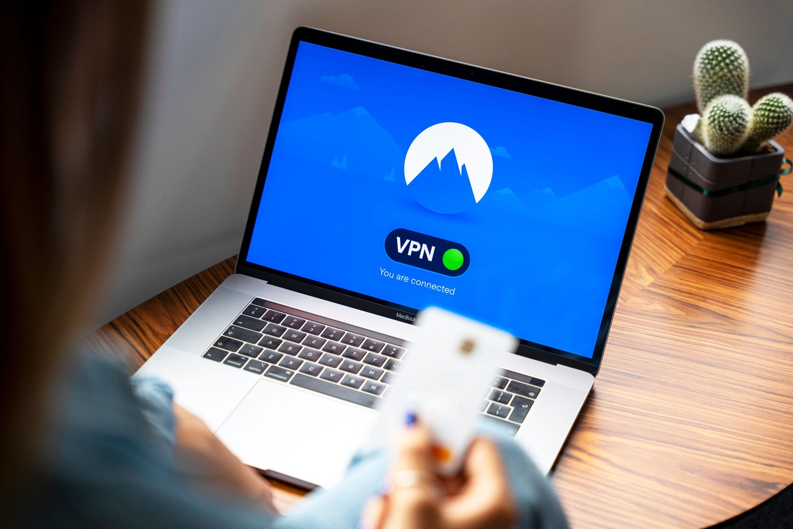 5 Passive Income Streams That Fund Beer Money Habits 4 Person setting up a Wi‑Fi hotspot on a laptop in a coffee shop
