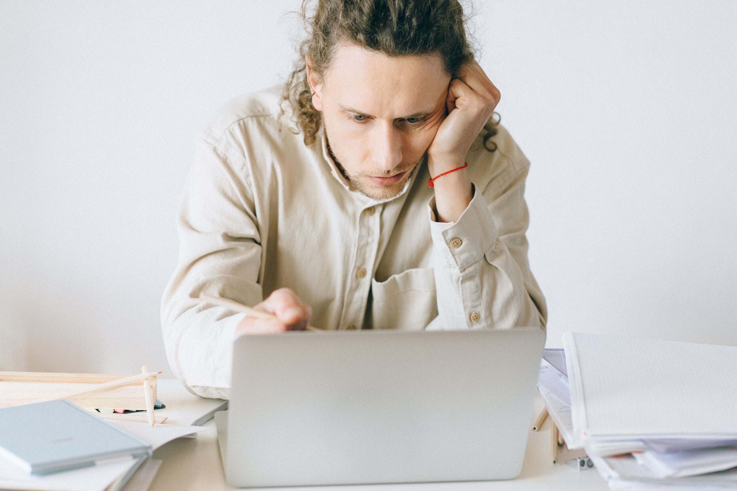 How to Build Multiple Income Streams as a Gig Worker 8 A frustrated gig worker looking at multiple phone screens with low earnings displayed