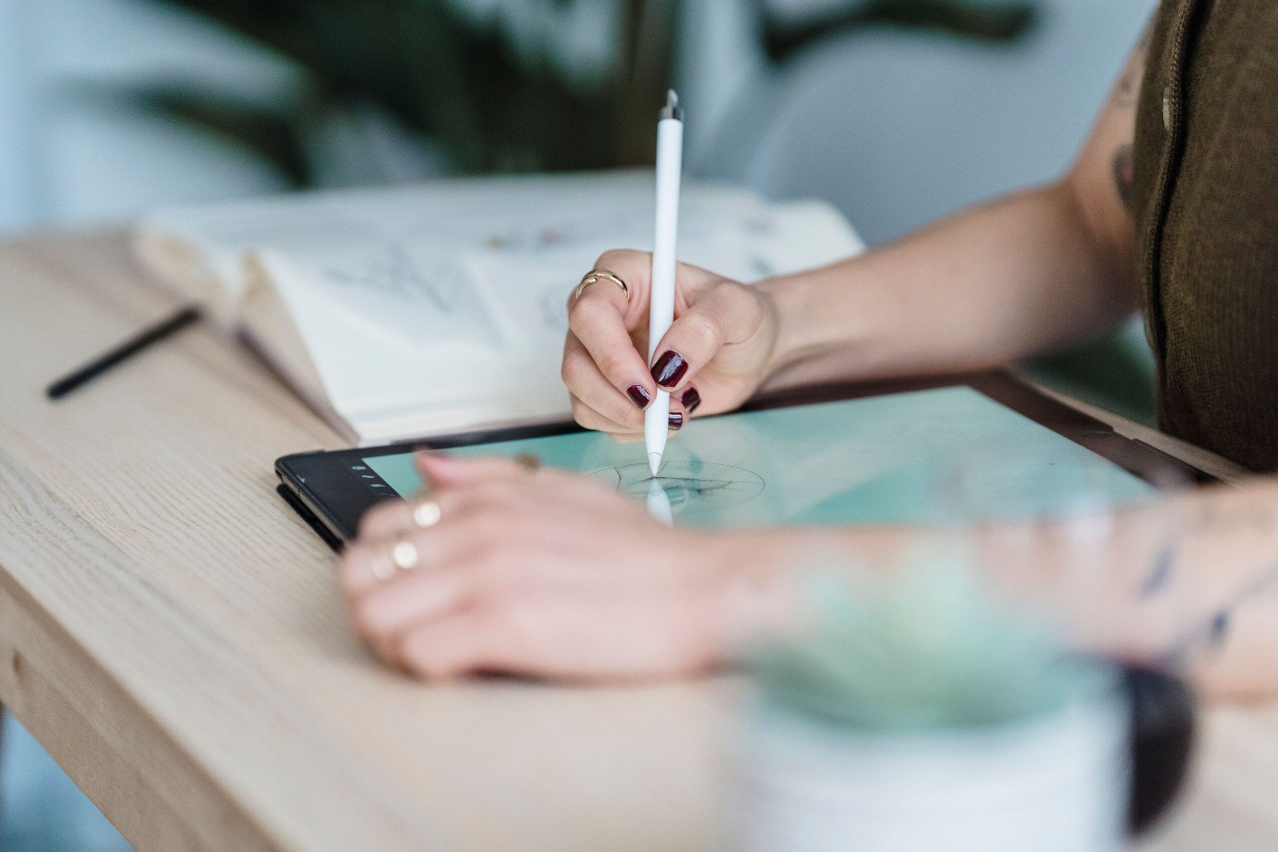 6 Side Hustle Apps Paying Weekly in 2026 7 a graphic designer working on a tablet with colorful icons around