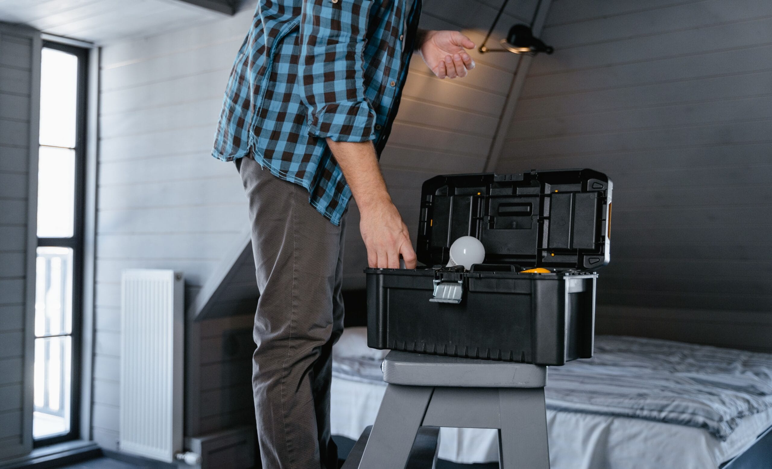 6 Side Hustle Apps Paying Weekly in 2026 6 a handyman fixing a kitchen sink with tools on a workbench