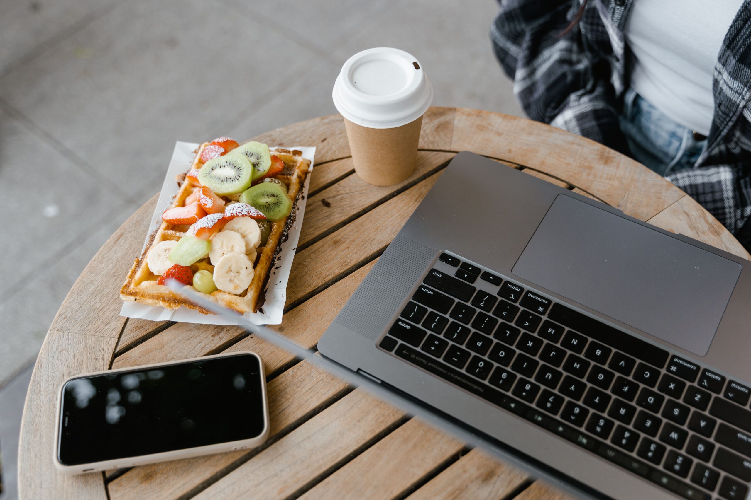 Freelancer working at a desk with a Wingstop meal box beside a laptop