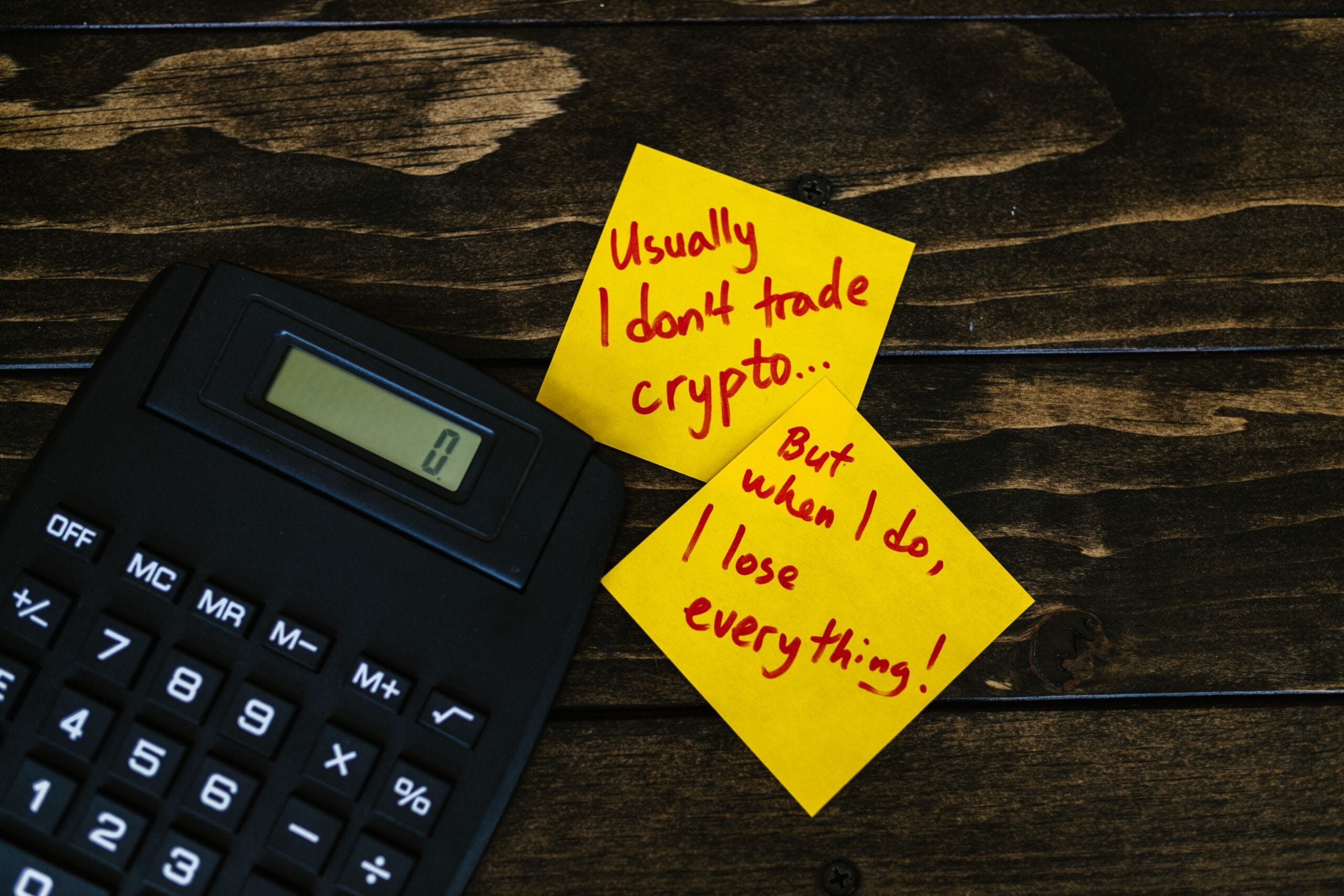 Forex Factory Calendar: Timing Trades for Extra Cash 7 Hand holding a calculator next to a coffee mug, symbolizing budgeting for trading risk
