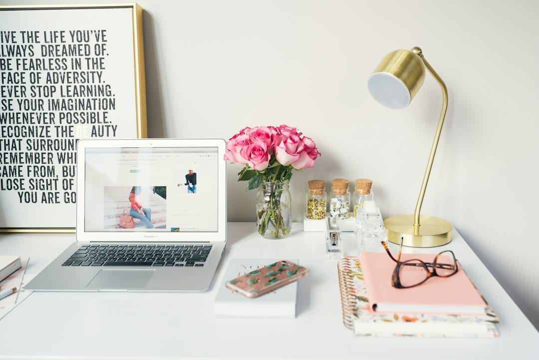 A organized desk workspace with coffee and a notebook tracking online side hustle income