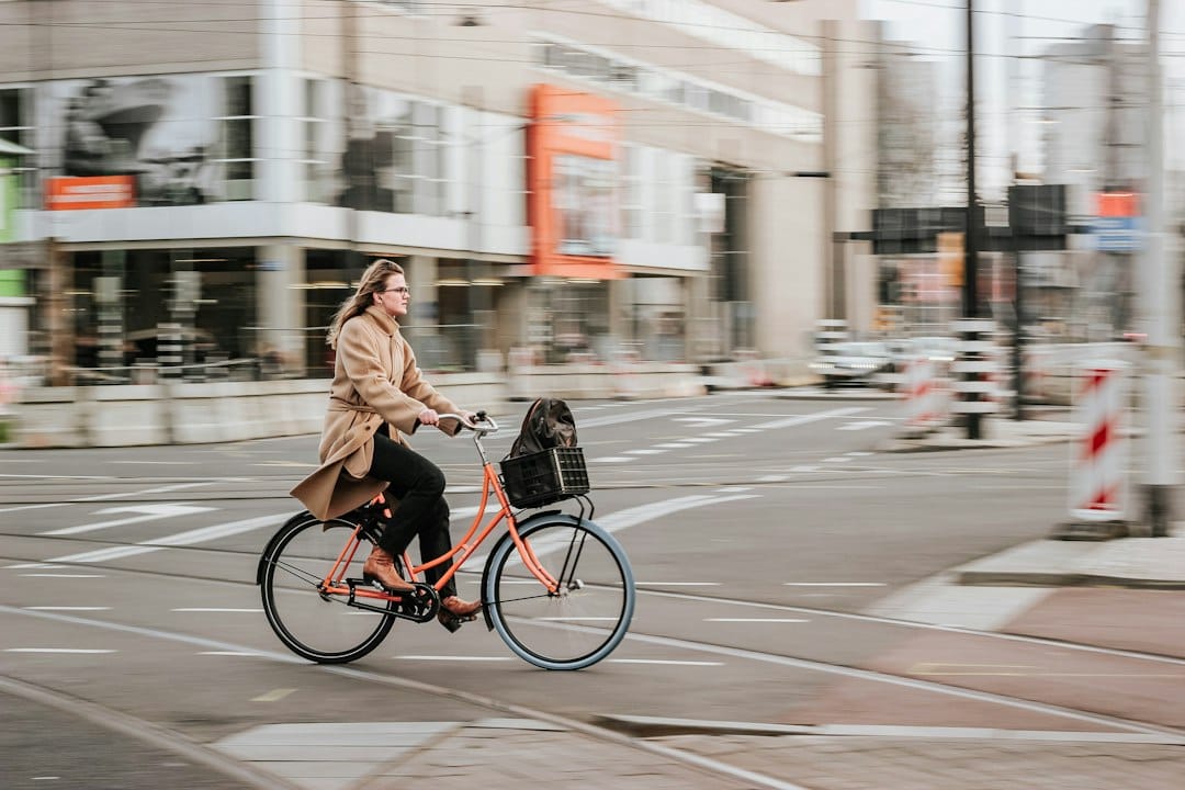 Budget travel: A Practical Guide 4 A cyclist riding through a historic European city center with cobblestone streets and colorful buildings