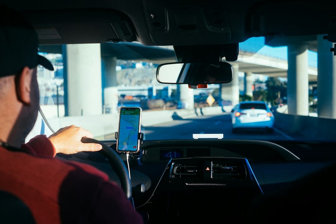 Gig Economy Side Hustles That Pay Daily or Fast in 2026 3 A rideshare driver checking earnings on a smartphone inside a car