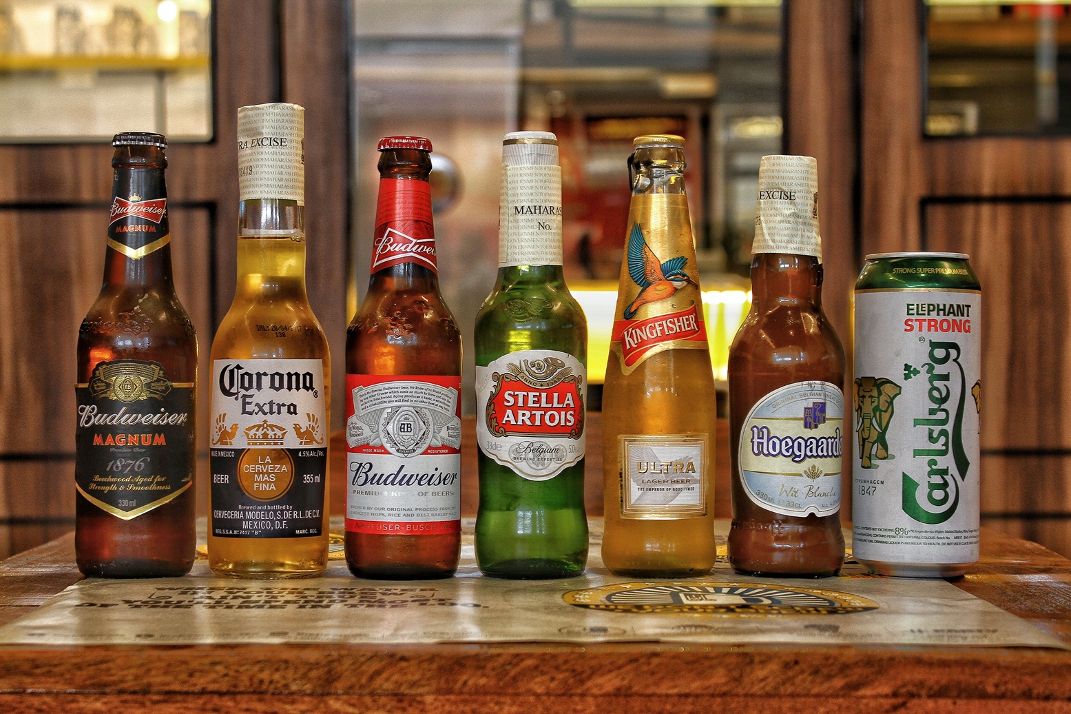 Best Beer Brands in India: Popular Indian & International Choices (2026) 1 Collection of international beer bottles displayed on a bar counter.