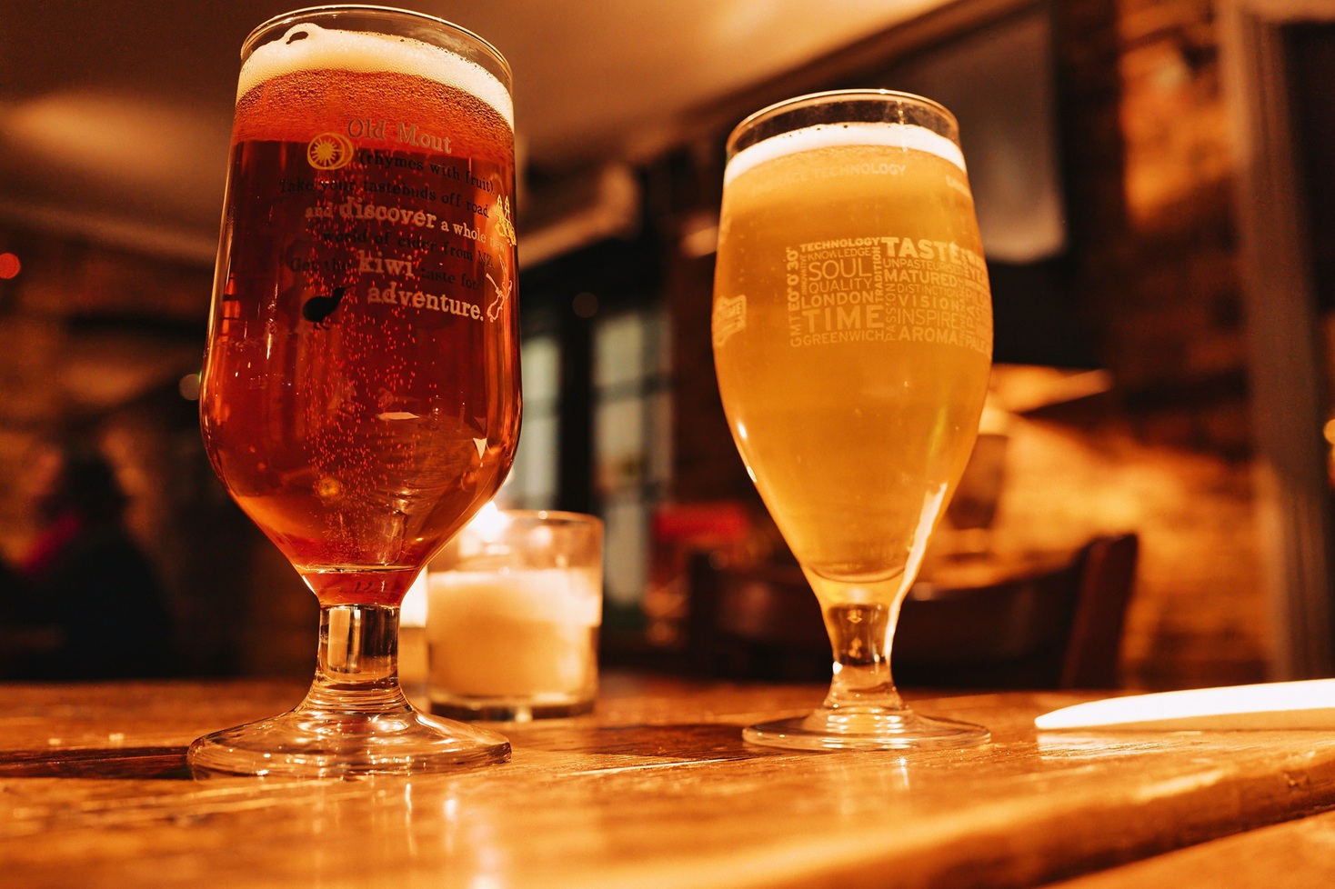 Types of Beer in India: Lager, Ale, IPA, Wheat Beer & More 1 Warm and inviting pub setting with two beers on a wooden table.