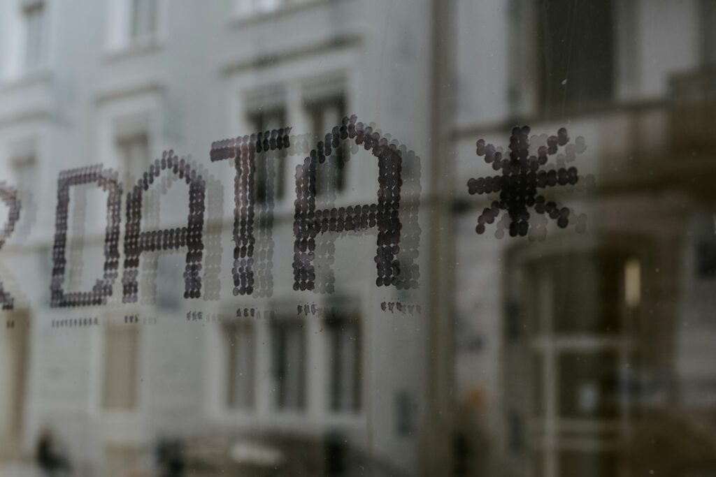 AI Training Data Jobs: Legit Platforms, Pay & Risks 2 The word DATA and a star symbol stenciled in dark dots on glass