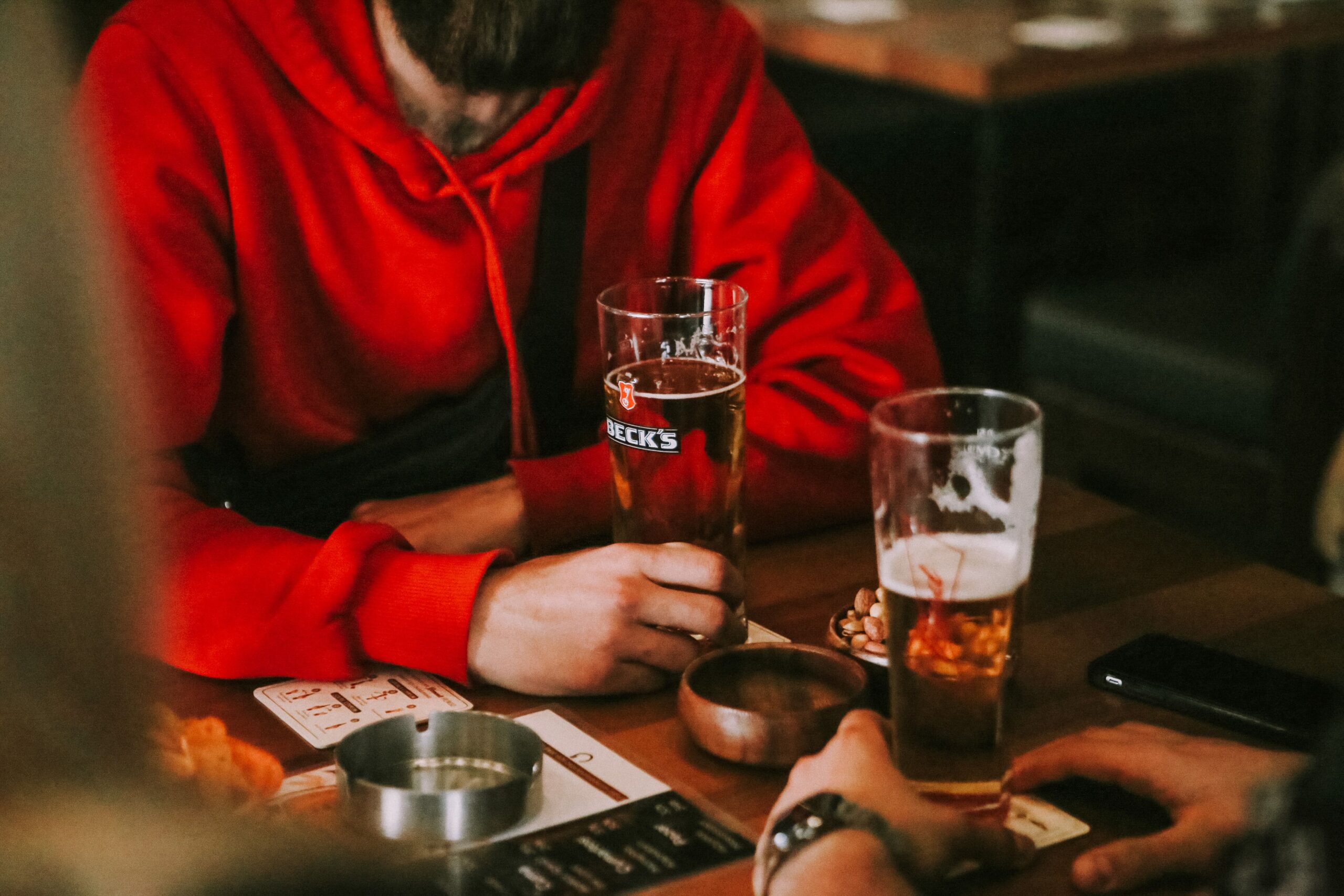 How to Make Money Selling Craft Beer Merch Online 3 group of friends wearing beer‑themed hoodies at a brewery