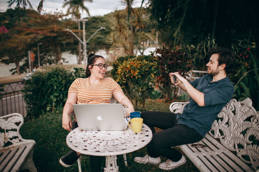 Freelancing: What It Is, How to Start, Jobs, Rates & Tips (2026) 2 A freelancer typing on a laptop while a chat window shows a client onboarding conversation, illustrating client acquisition