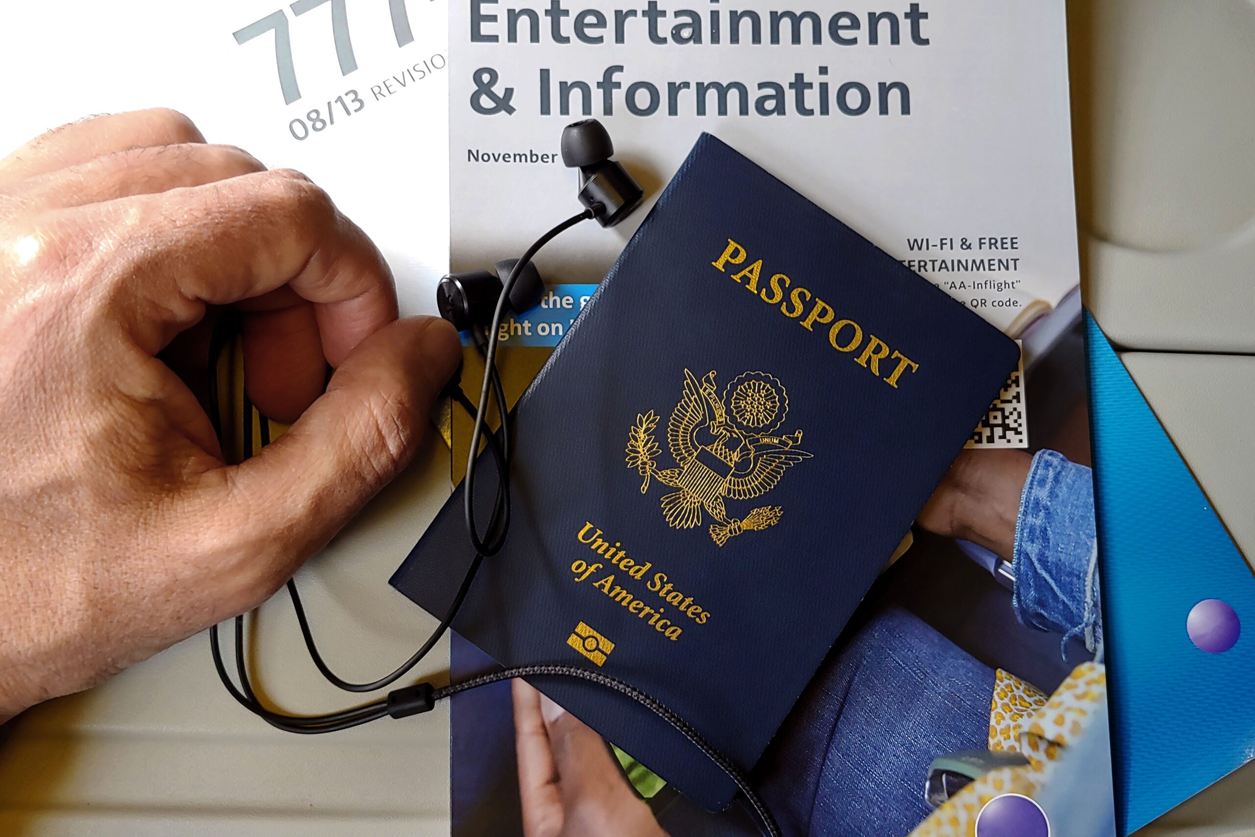 A traveler booking budget airline tickets on a laptop computer with a passport nearby