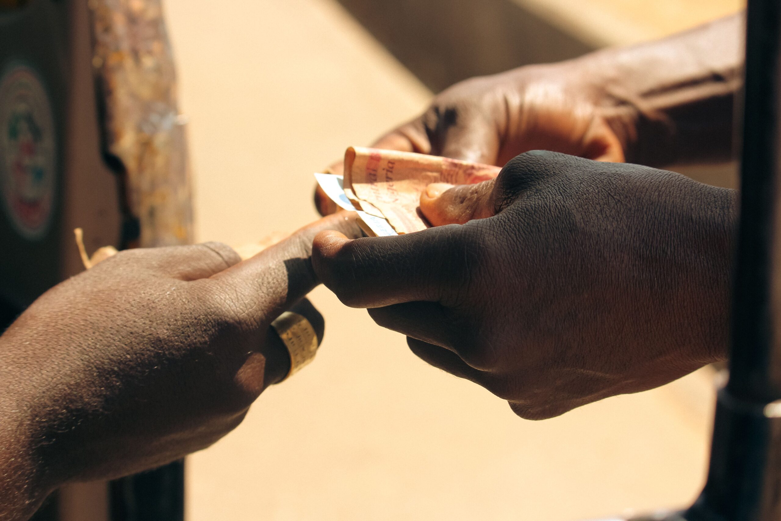 Where to Sell Old Electronics for Cash: Best Places & Tips 3 two people exchanging a smartphone for cash at a café