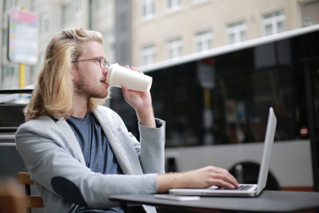 Freelancing: What It Is, How to Start, Jobs, Rates & Tips (2026) 5 A freelancer working on multiple screens, one showing a calendar, another a client dashboard, symbolizing business growth and scaling