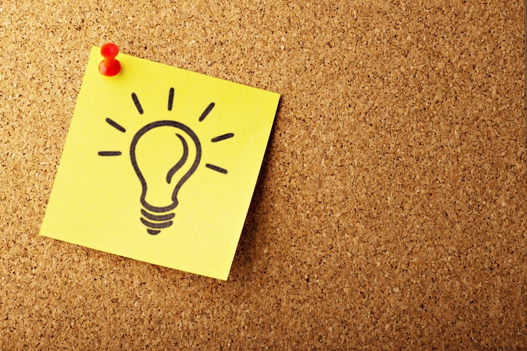 Small Business Guide: How to Start, Run, and Grow a Business 2 Person sketching ideas on a whiteboard with sticky notes