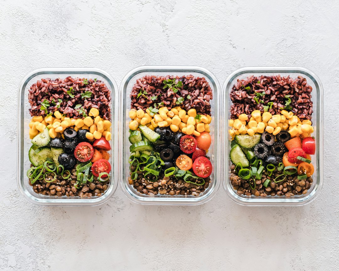 Nutrition Tips: Where to Start 4 Organized meal prep containers filled with quinoa, beans, and roasted vegetables on a kitchen counter
