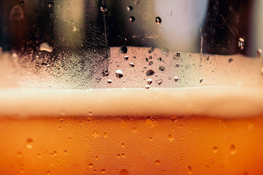 Affiliate Marketing for Craft Breweries: A Guide to Earning Commissions 4 bartender pouring craft beer into a tasting glass with laptop nearby