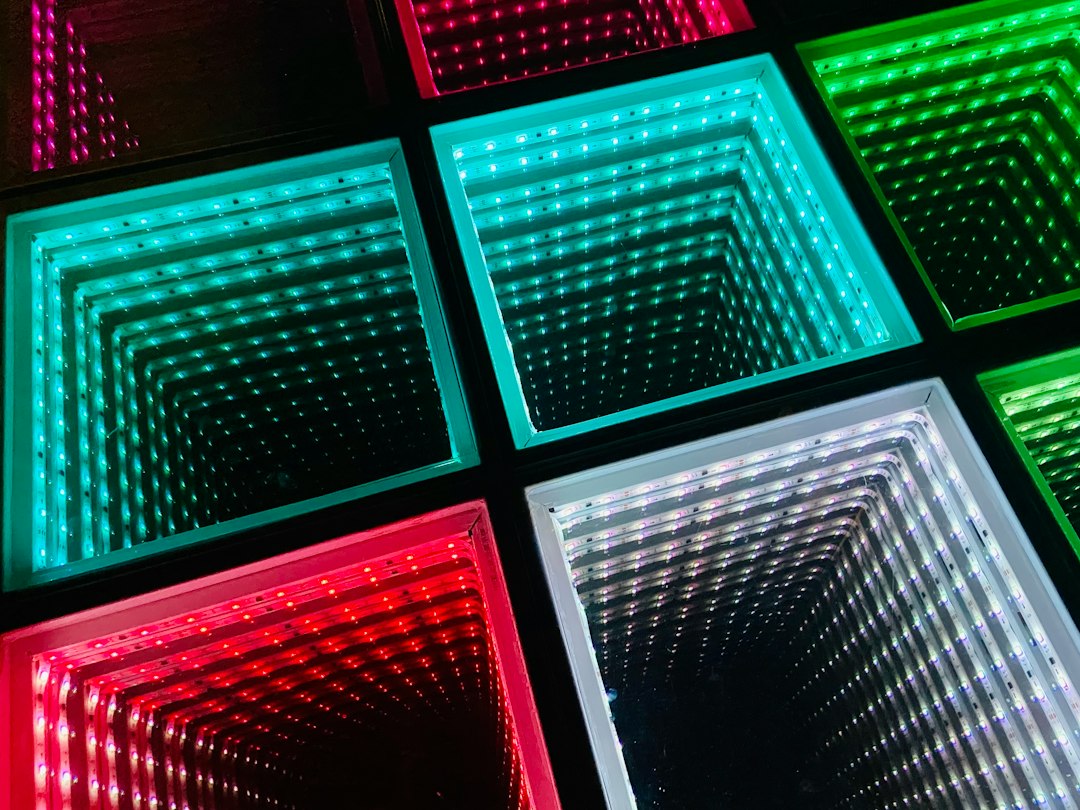 Growing For Beginners: Where to Start 4 Hand holding a LED grow light panel over a pot of seedlings
