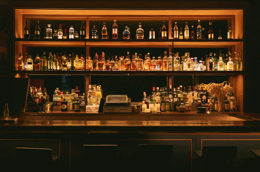 Turn Empty Bottles into Extra Cash: The Ultimate Can Recycling Side Hustle 5 bartender collecting empty beer cans from a bar counter